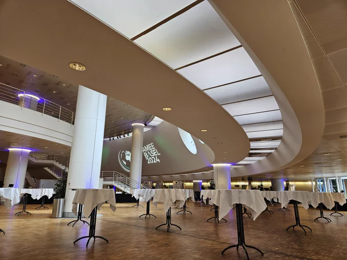 Basel conference centre rounded architecture projector showing AMEE Basel 2024