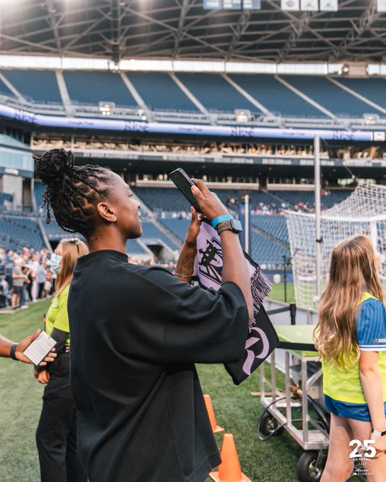 Jewell Loyd taking a photo on her phone