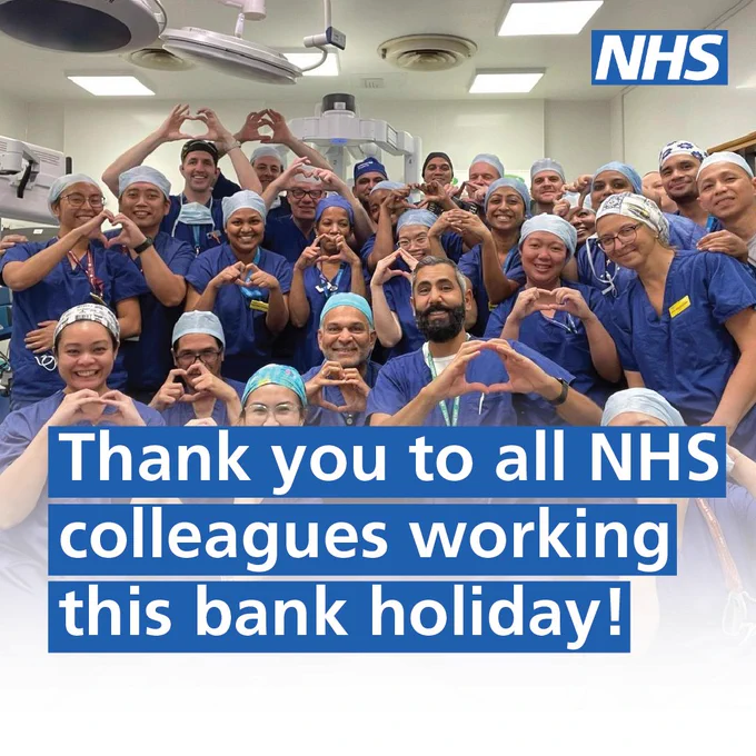 Text: Thank you to all NHS colleagues working this bank holiday! Image:  A large group of NHS staff who are all wearing surgical scrubs are standing in a surgical ward making the love heart shape with their hands. 