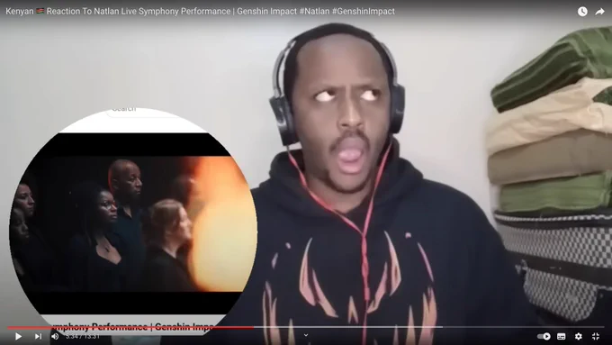 A screenshot from YouTube of a man wearing headphones listening to music, looking surprised.