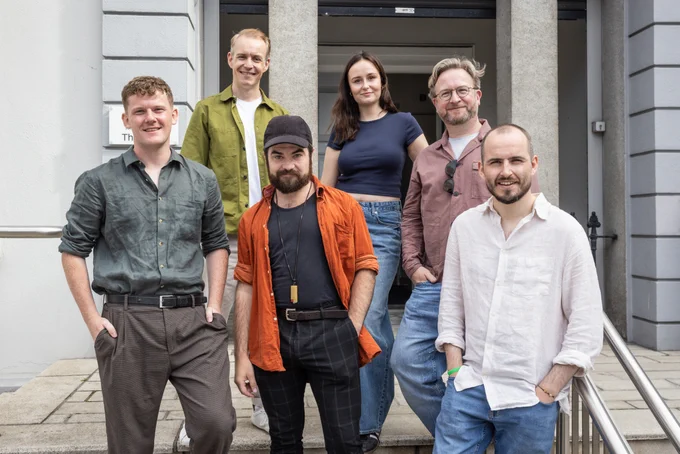 6 actors standing together for a photo on the steps outside the rehearsal room for Druid's The House