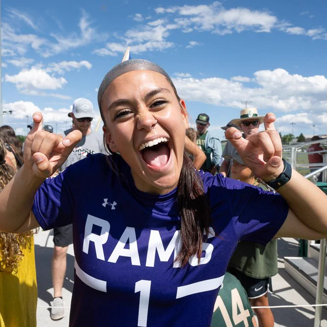 C S U soccer player Libby Brooker making the Rams hand sign with her hands while posing for a picture. 