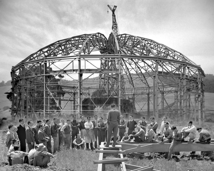 Ernest O. Lawrence talking to workers near construction site of 184-inch cyclotron. 