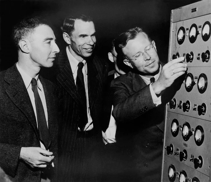 Ernest O. Lawrence, Glenn T. Seaborg, and J. Robert Oppenheimer in early 1946 at the controls to the magnet of the 184-inch cyclotron.