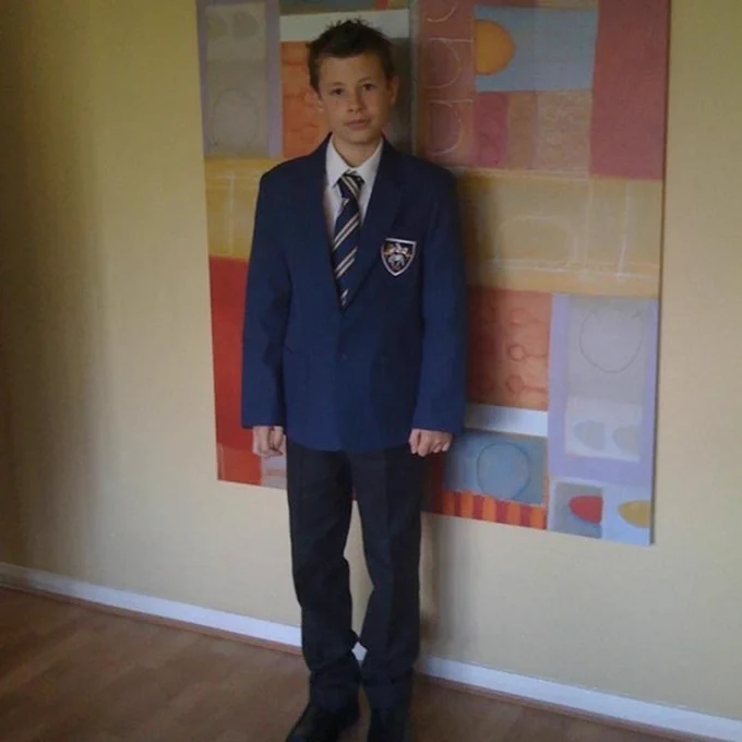 Callum getting ready for his first day at Fulneck School, his high school. He is 11 years old at this point, wearing his uniform and looking nervous.