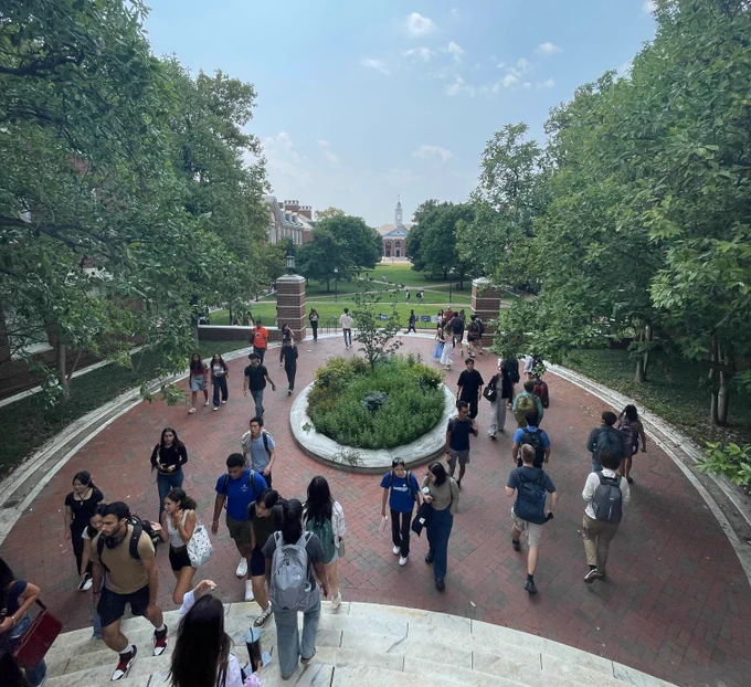 Several students walking outside on the Homewood campus on a sunny day.