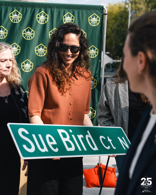 Sue Bird holding a replica Sue Bird Ct street sign