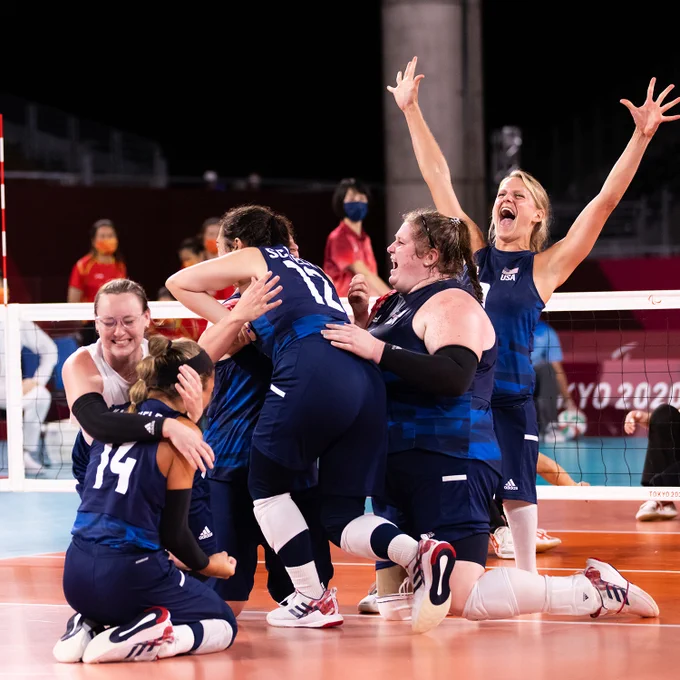 The U.S. Women's Sitting Team huddles on center court after the gold medal point in tokyo.