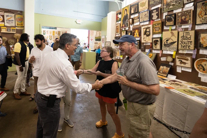 Secretary Becerra shaking a man's hand 