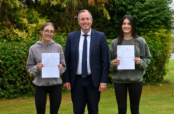 Education Minister Paul Givan pictured at Belfast High school in Newtownabbey with pupils Holly Lundie and Amy French