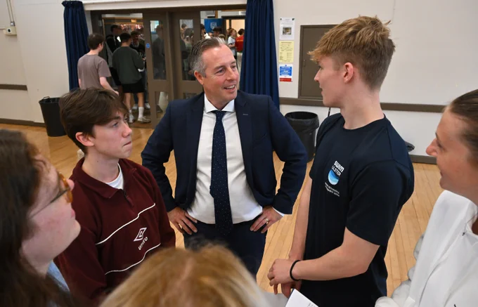 Education Minister pictured at Belfast High school in Newtowanbbey on “A” level results day with Daniel Harvey  and Jayden Lloyd 