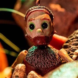 An acorn puppet with a worried look