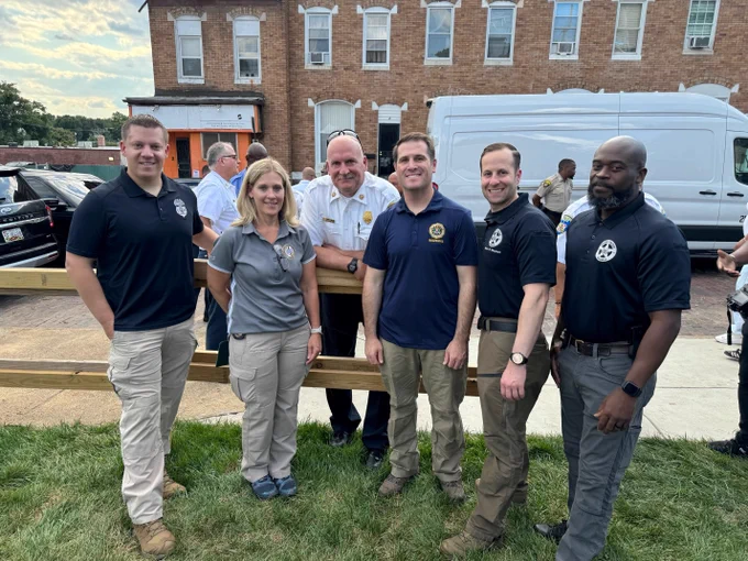 Law enforcement personnel pose for a photo at Baltimore Police Department's celebration of National Night Out.