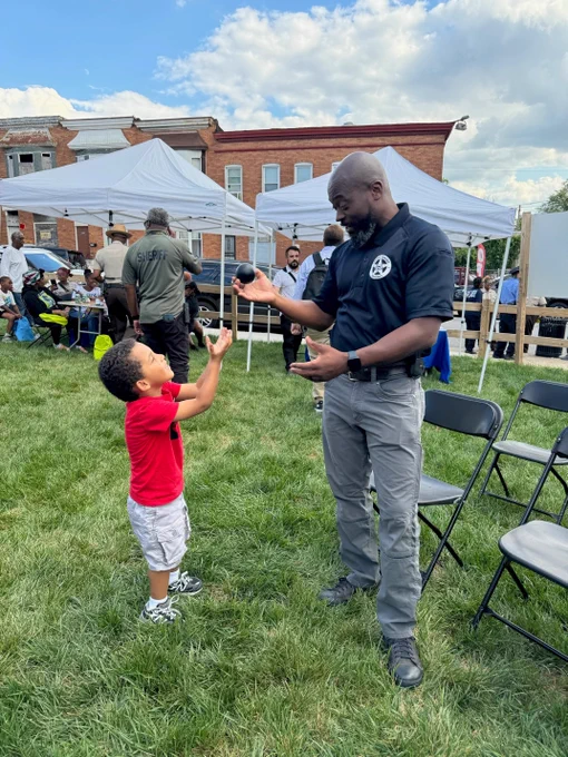 A child engages with a Deputy U.S. Marshal.