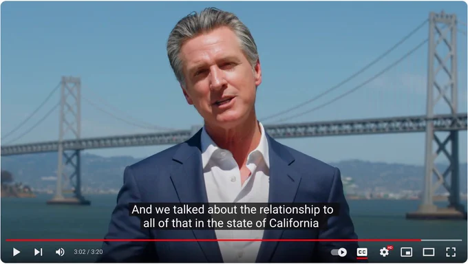 California Governor giving a speech with the Golden Gate Bridge in the background.
