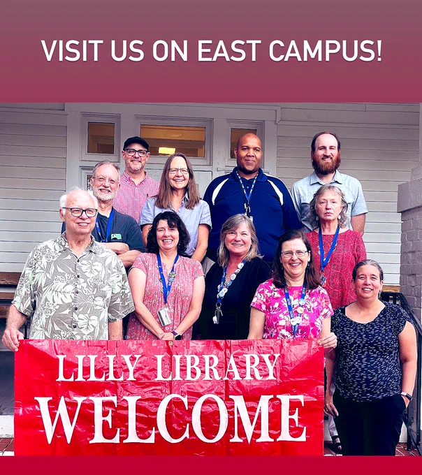 Librarians holding a welcome sign