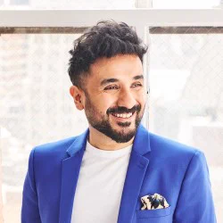 A smiling man in a blue jacket