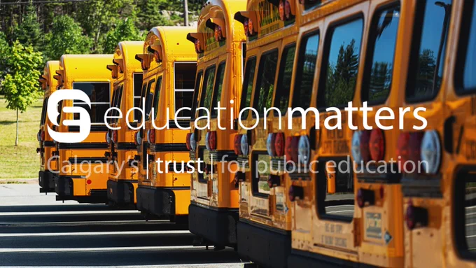 Row of school buses in background - EducationMatters logo in front