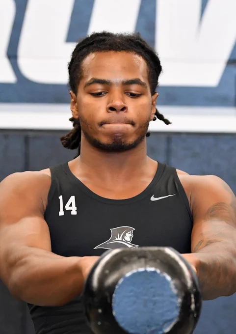 Corey Floyd Jr. swinging a kettlebell weight