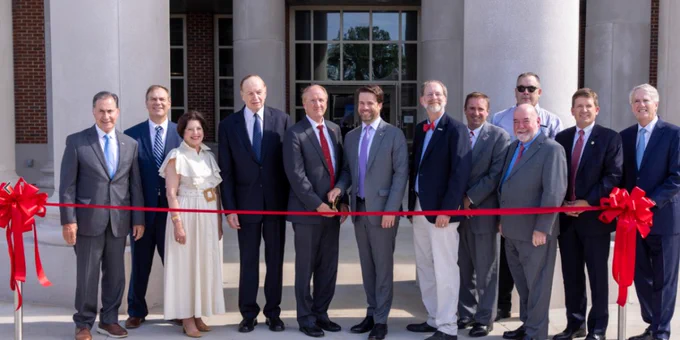 University of Alabama President, Stuart Bell, and Interior’s Principal Deputy Assistant Secretary for Water and Science, Michael Brain, cut the ribbon on the new USGS Hydrologic Instrumentation Facility. People holding the ribbon include members of University of Alabama leadership, state and federal representatives, and members of USGS leadership. Credit: University of Alabama. 