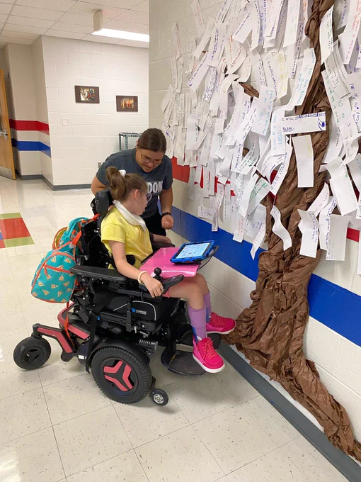 Student putting wish on tree