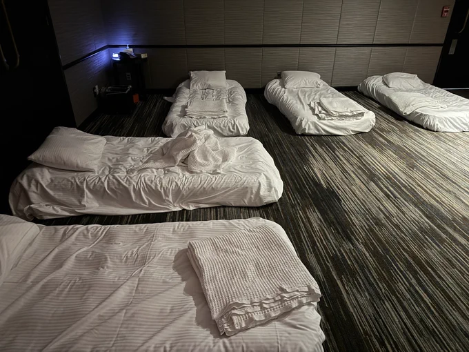 A hotel conference room with a few cozy single beds