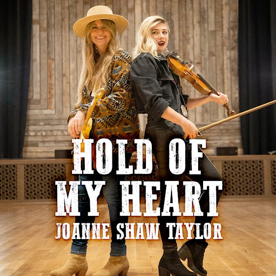 Single album cover of Joanne Shaw Taylor and fiddle player Sav Madigan, for the recording of the song titled Hold Of My Heart, the music video of which is featured on FreeV.Com