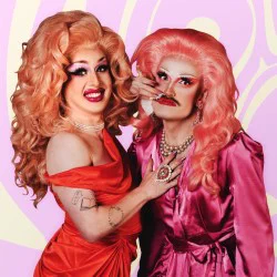 two drag queens on a pink background