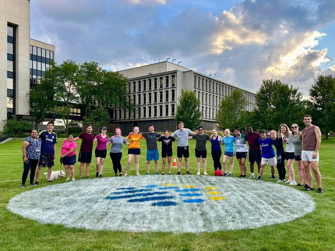 Posing with the CAS logo at the kickball field