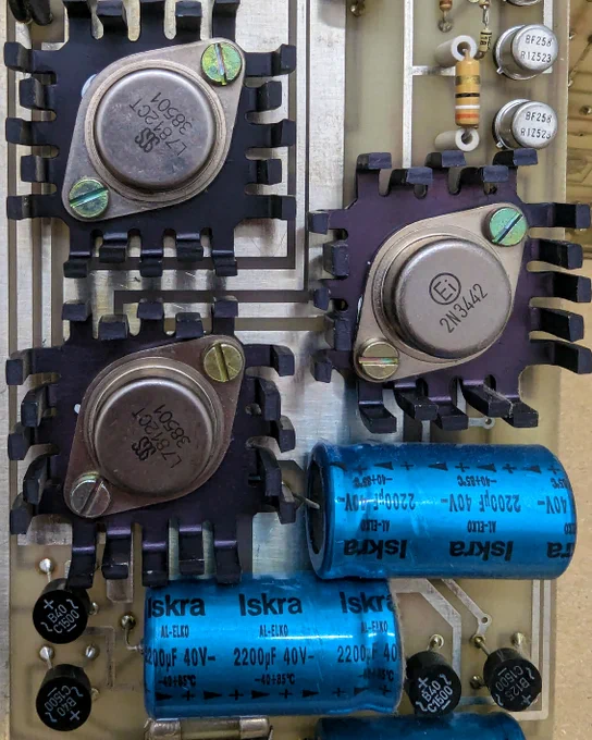 Light brown circuit board with various elements.
