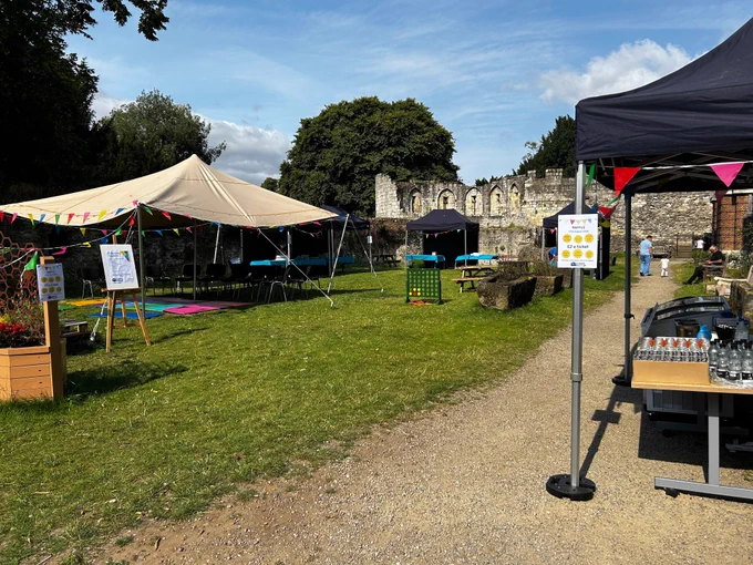 Library lawn set up for the fundraiser with stalls for cakes and games and events 