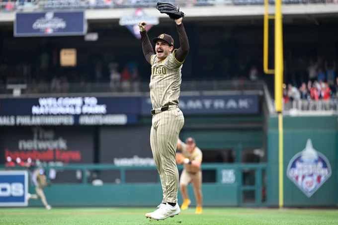 Dylan Cease celebrates after the final out of his no-hitter. He is wearing a tan-colored pinstripe Padres jersey.