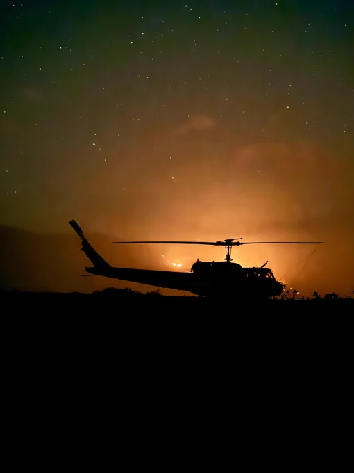 Silhouette of a helicopter against the glow of the Warner Peak Fire in Oregon. 