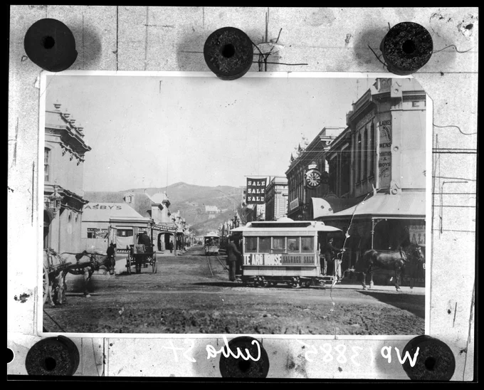 Horse Trams in Cuba Street, corner of Dixon Street. Te Aro House in the background is advertising a Salvage Sale, 1885. (Photographer: P C Sorreli)