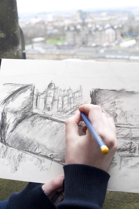 A child sketching the view from Edinburgh Castle.