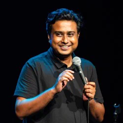 A smiling man with a microphone