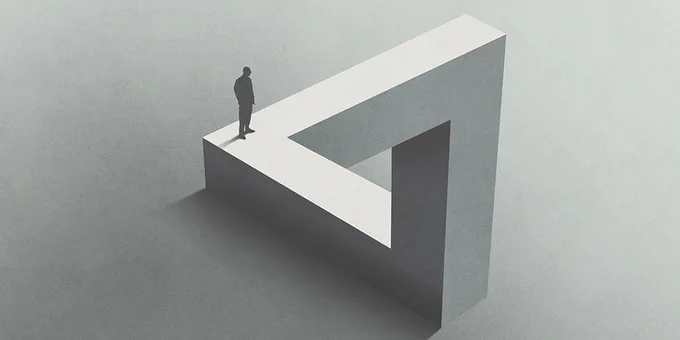 A small man standing on a triangle.