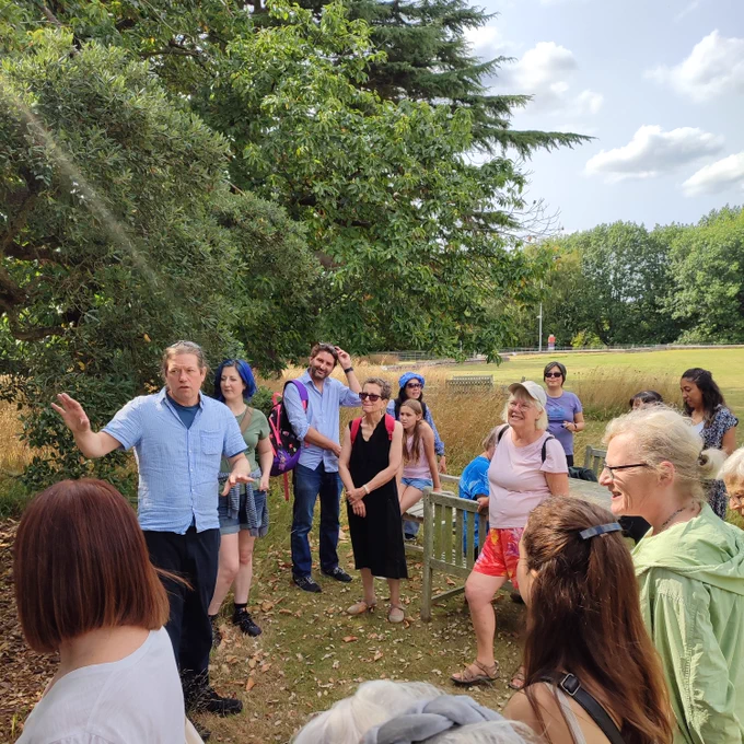James Canton talks about the trees to a group of walkers in Wivenhoe Park