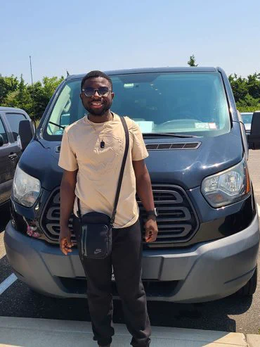 Samuel Osei Poku, graduate student in the Department of Civil Engineering, in front of the beach access shuttle. 