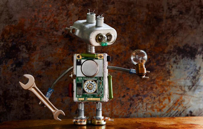 robot holding a wrench and a light bulb