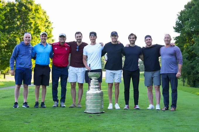 Carter Verhaeghe and friends pose with the Stanley Cup at a golf course. 