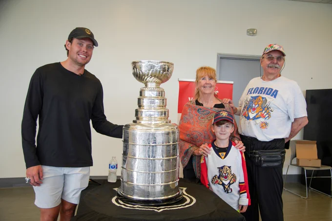 Carter Verhaeghe poses with the Stanley Cup and fans. 