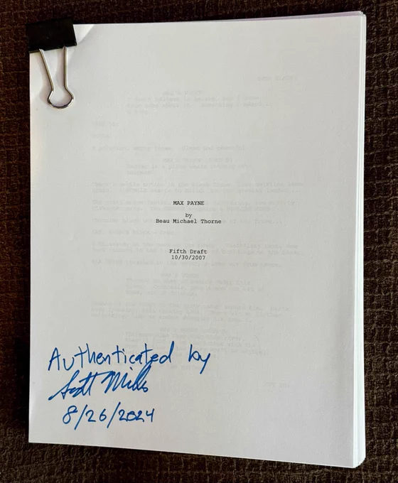 A photo of the fifth draft of the Max Payne movie script, dated 10/30/2007, written by Beau Michael Thorne. The script is authenticated by Scott Miller, founder of Apogee/3D Realms, with his signature and the date 8/26/2024 written in blue ink on the cover page. The document is clipped together with a black binder clip and placed on a brown textured surface.