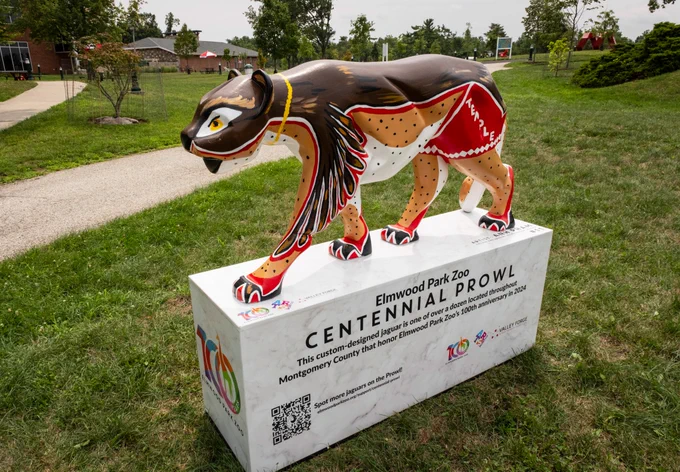 Painted statue of a Jaguar on a base labeled "Centennial Prowl, Elmwood Park Zoo.