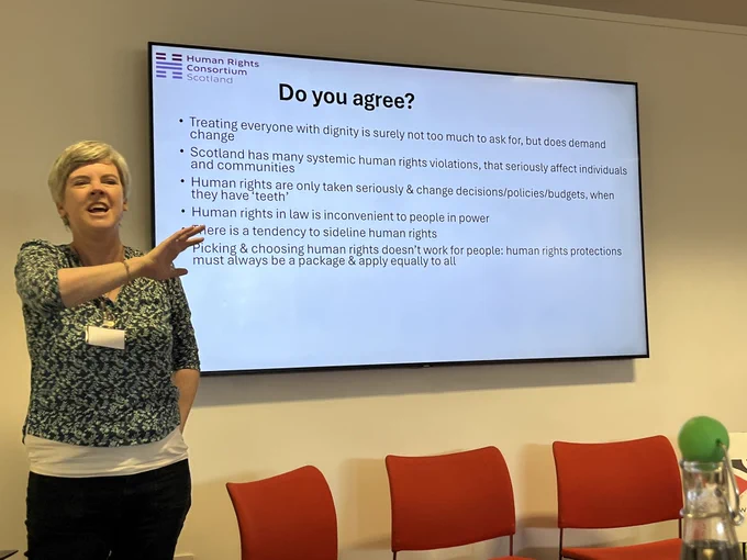 Mairi speaking in front of slides, asking if you agree
