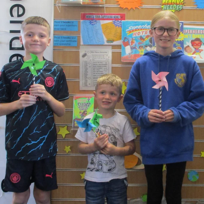 three children holding a pinwheel