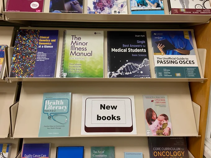 Various new books on display on a shelf.
