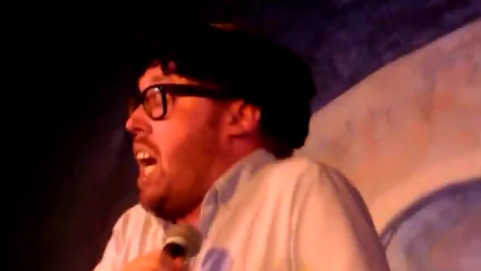 Screenshot of John Kearns singing along to a track with nonsense sounds at an ACMS gig (link to video below)
