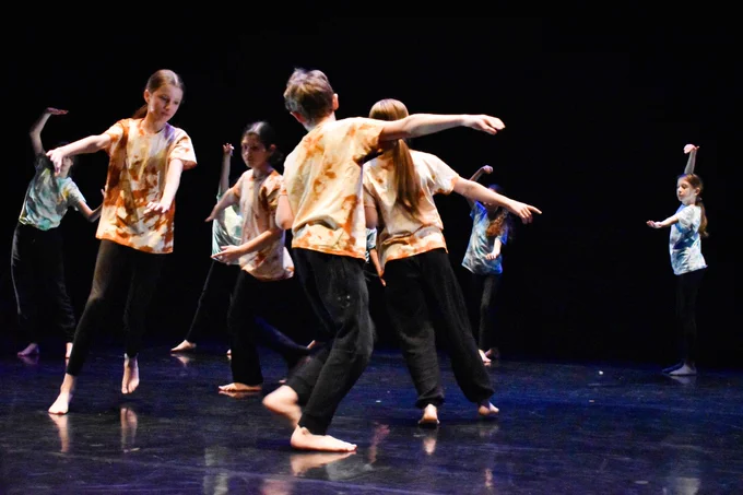Photo of a mixed group of Camden secondary pupils performing at a youth dance festival in King's Cross.