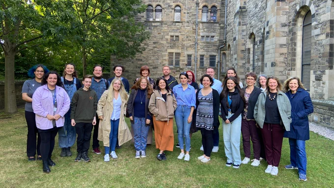 Members of staff from the Scottish Youth Parliament and The Scottish Parliament's Participation and Communities Team alongside two MSYPs in the garden at SYP's office in the Mansfield Traquair Centre in Edinburgh.
